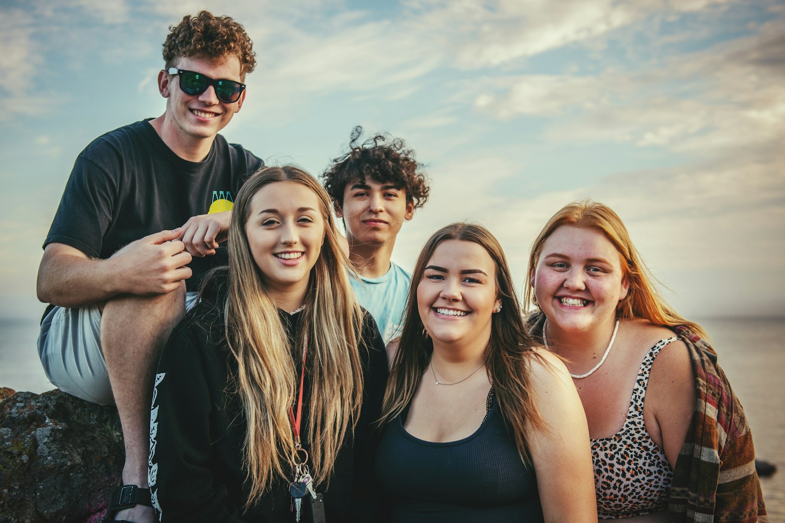 A group of five Bridgewell members laughing together outdoors