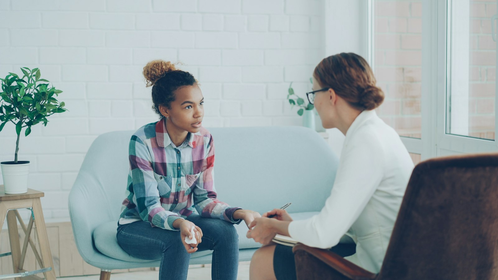 A mentor and a young person talking together